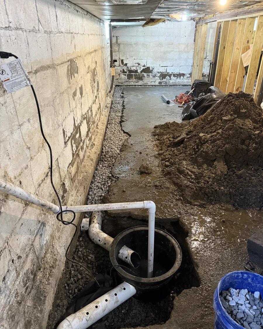 Open perimeter trench with washed stone, perforated pipe and the sump basin set at the low point